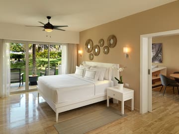 a bedroom with a ceiling fan and a bed