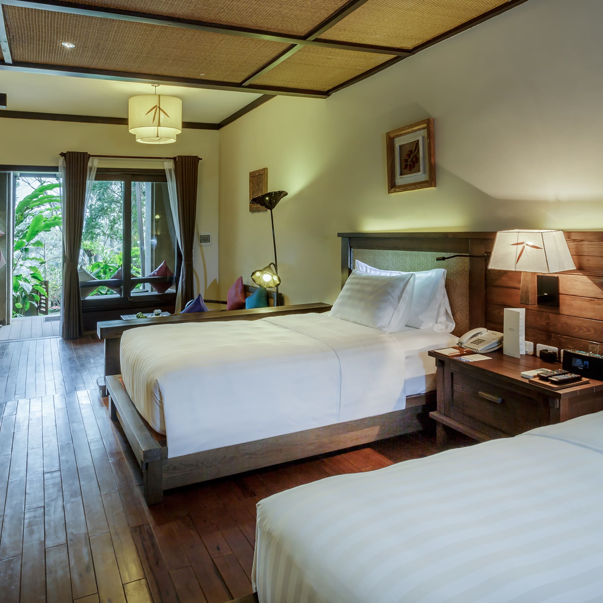 a room with two beds and a wood floor