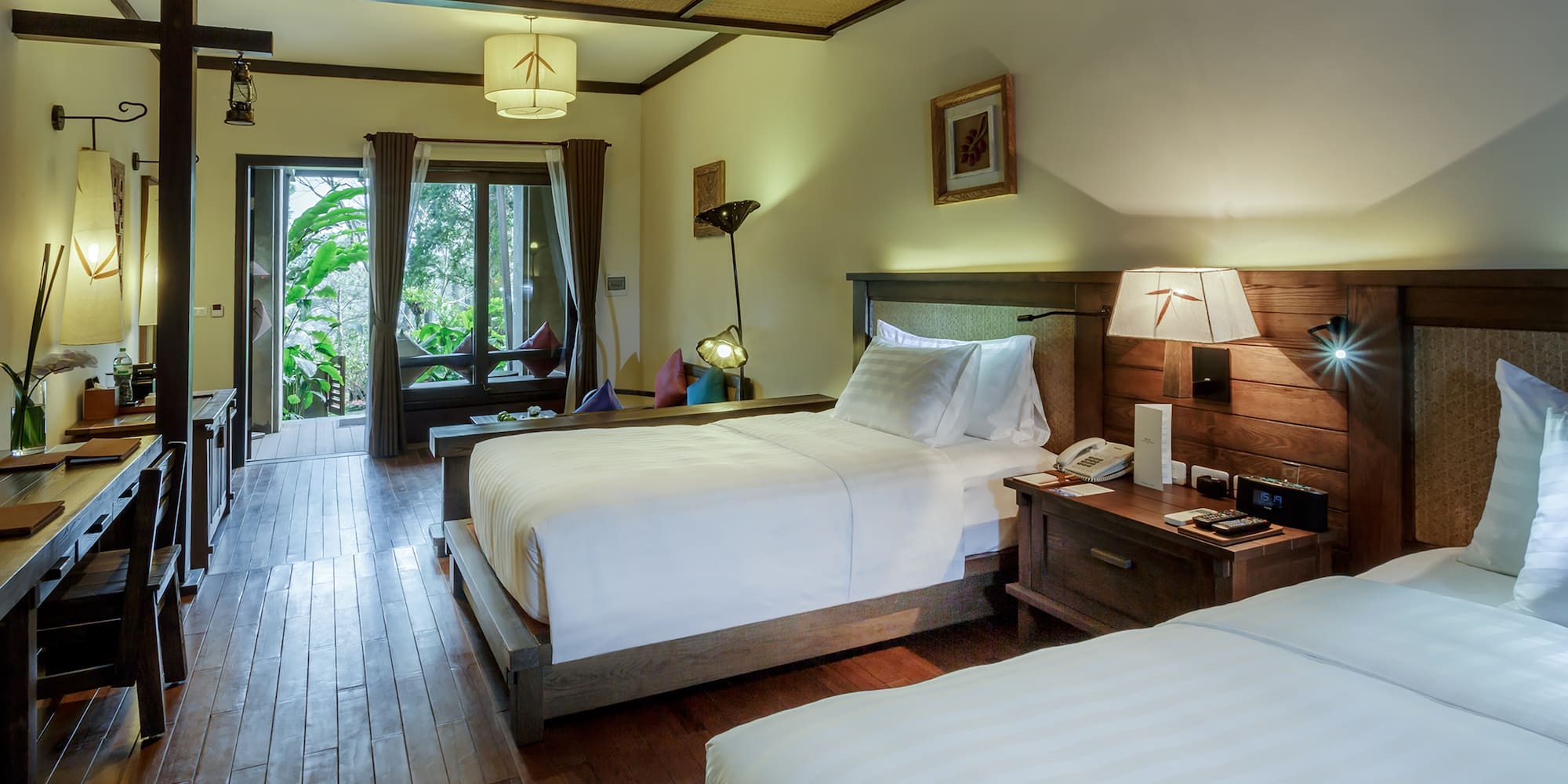 a room with two beds and a wood floor