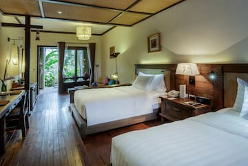 a room with two beds and a wood floor