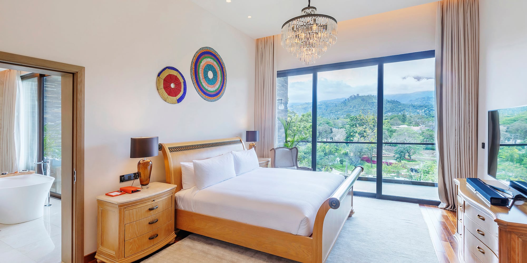 a bedroom with a bed and a chandelier