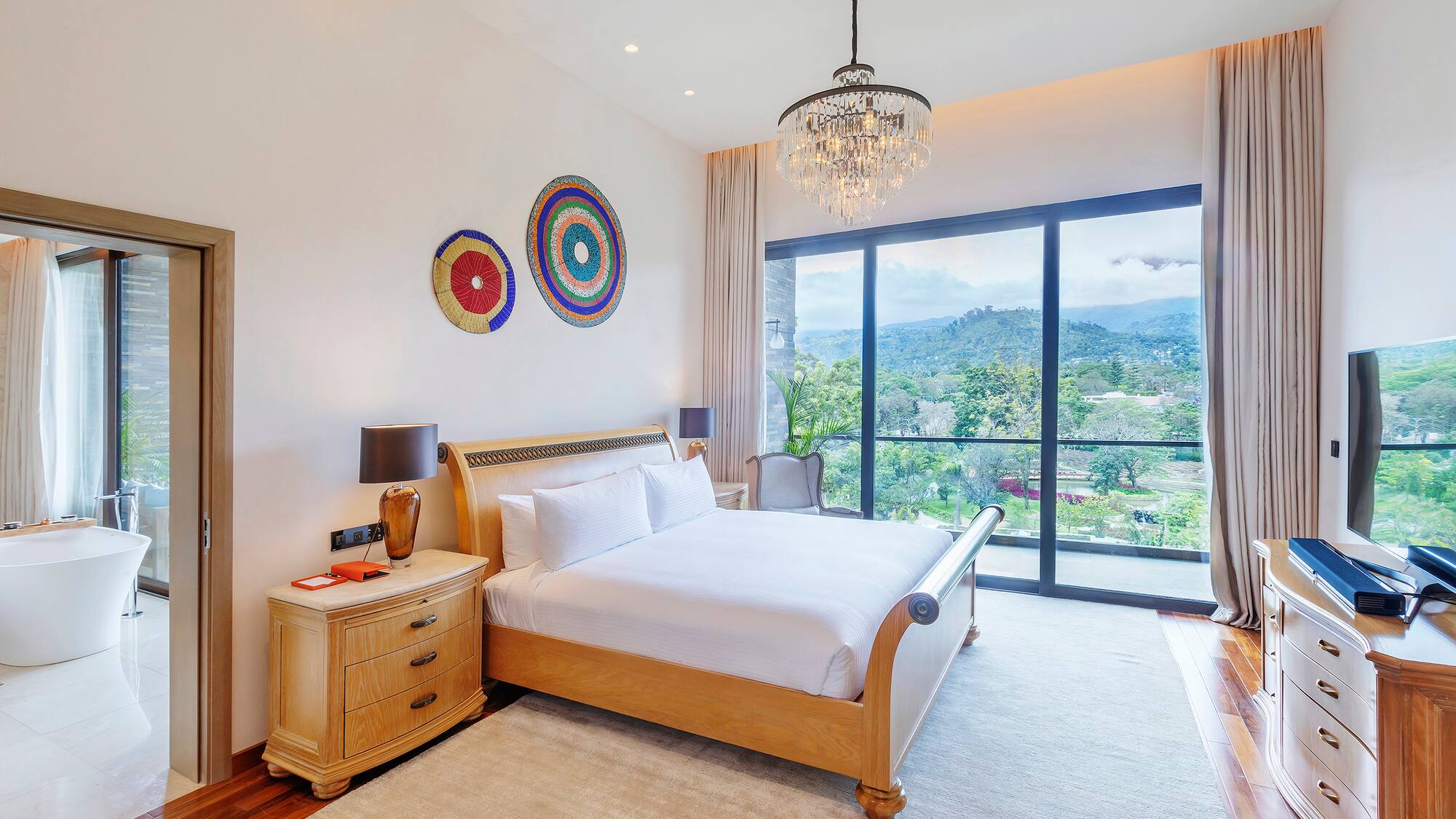 a bedroom with a bed and a chandelier