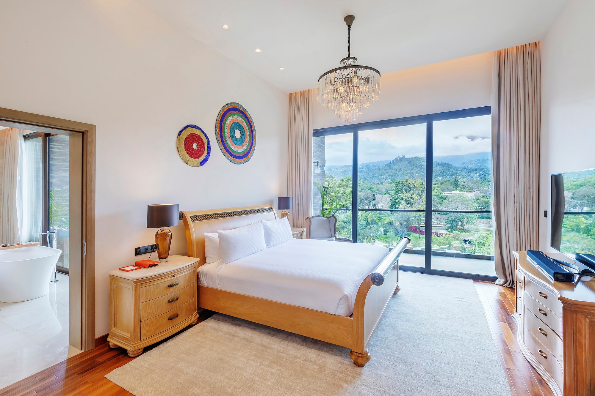 a bedroom with a bed and a chandelier