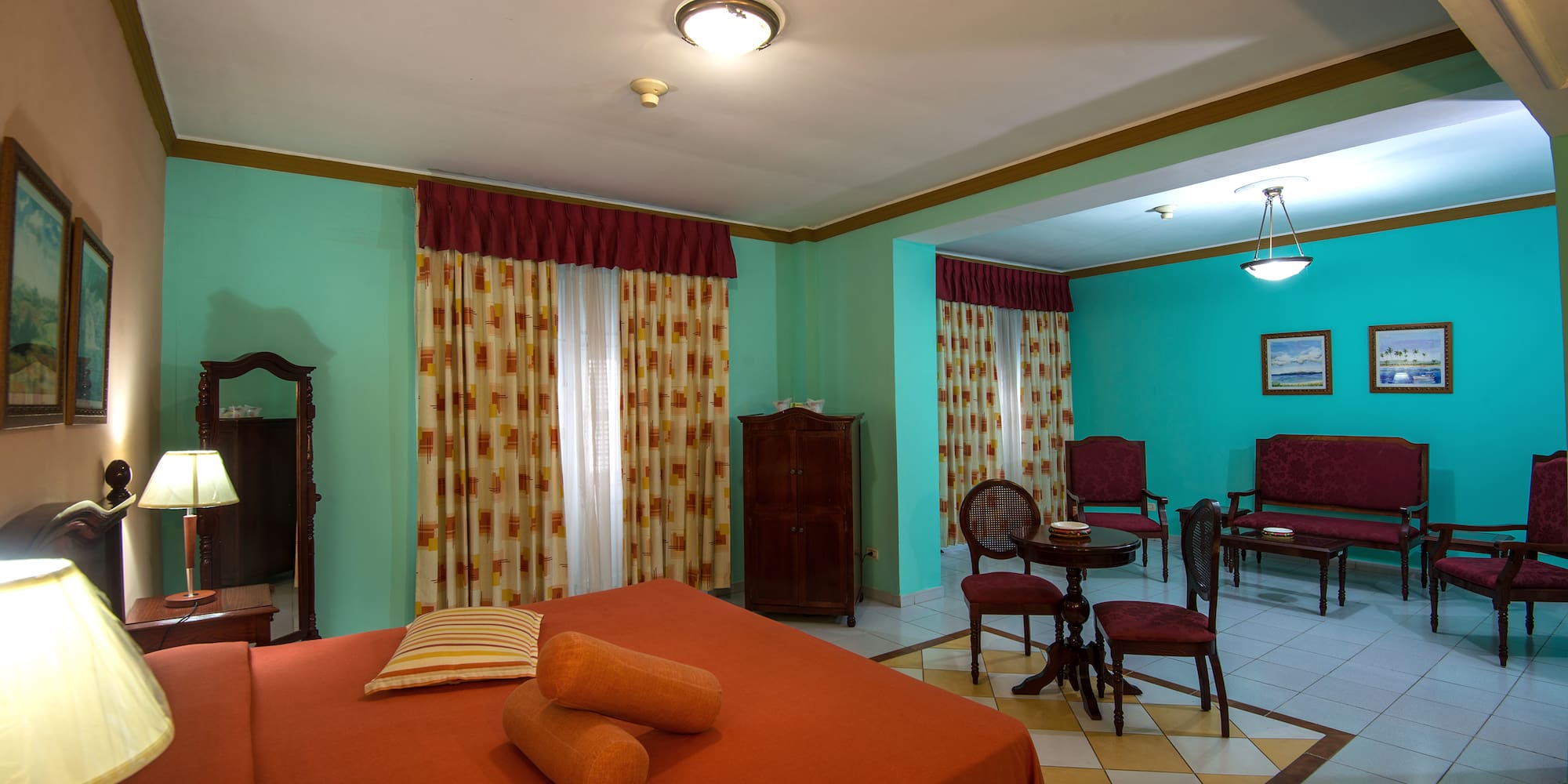 a room with a bed and chairs