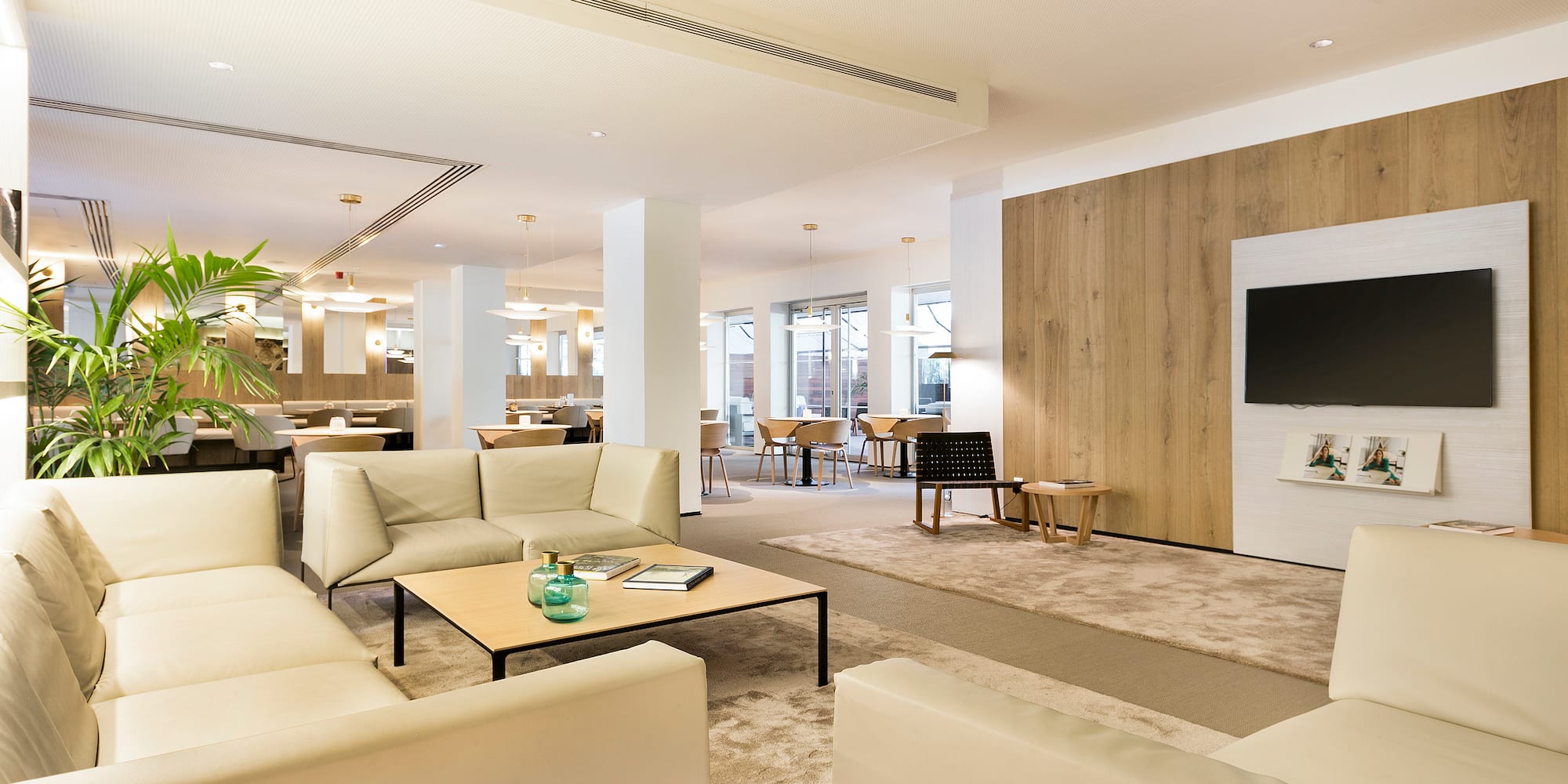 a room with white furniture and a wood paneled wall