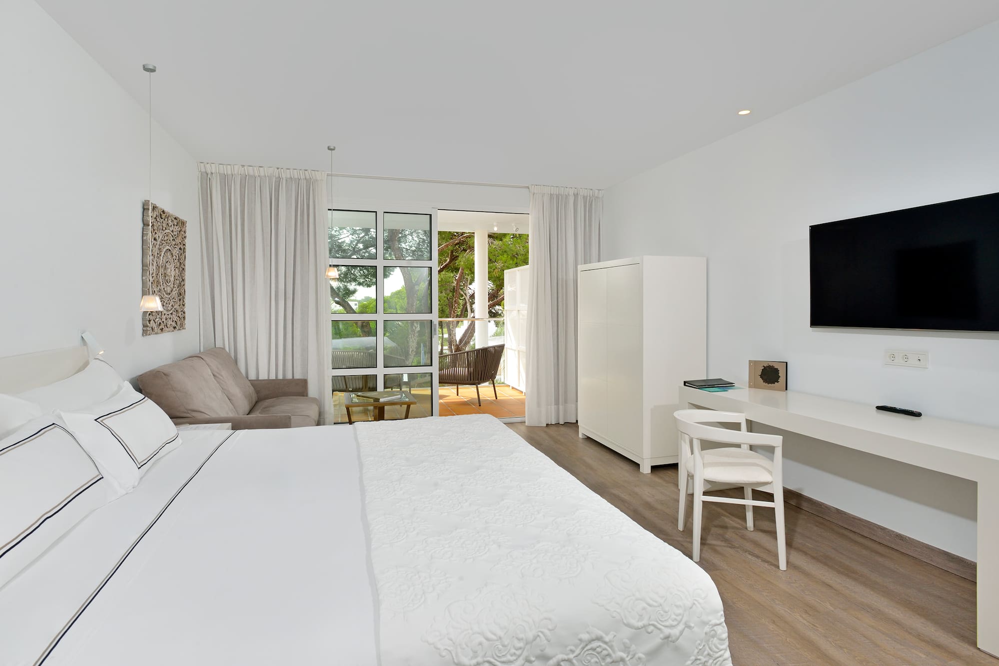 a bedroom with a bed and a tv