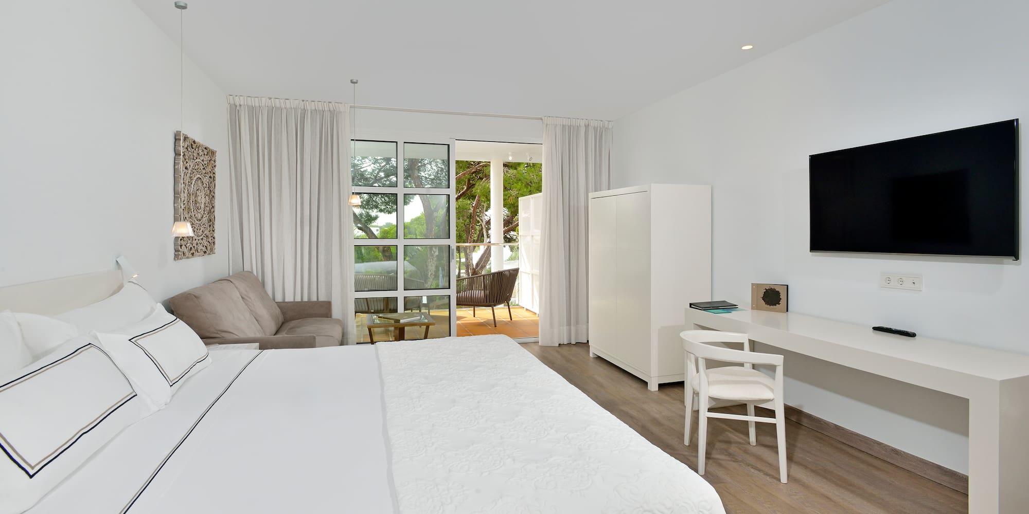 a bedroom with a bed and a tv