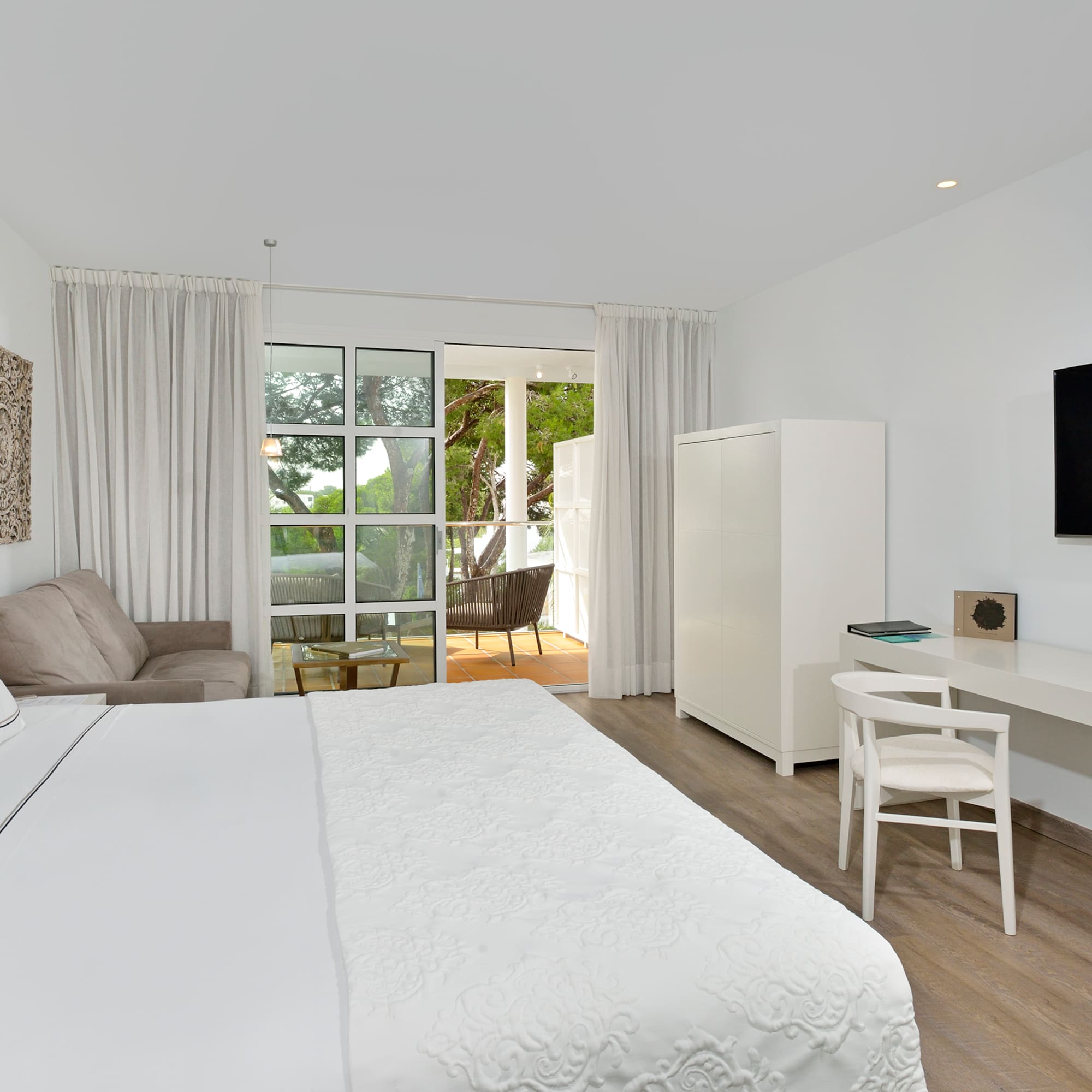 a bedroom with a bed and a tv