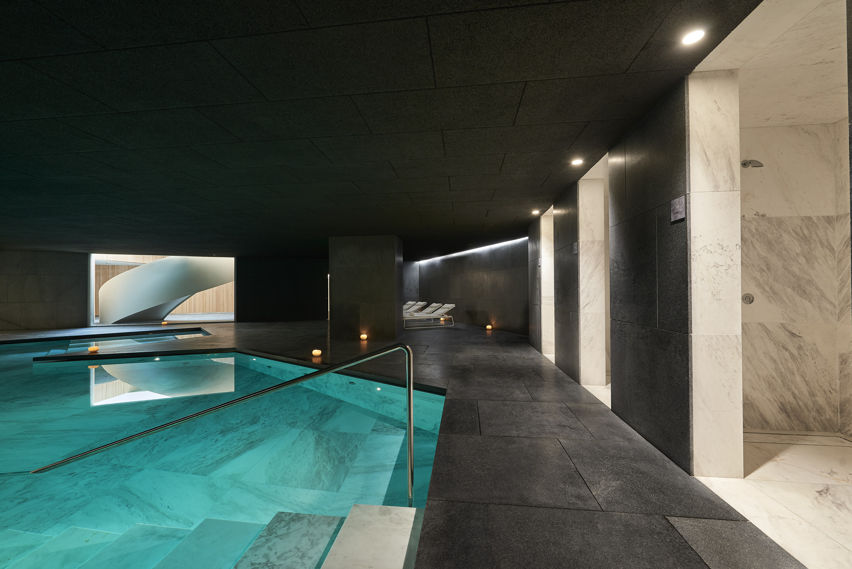 a pool with a deck and chairs