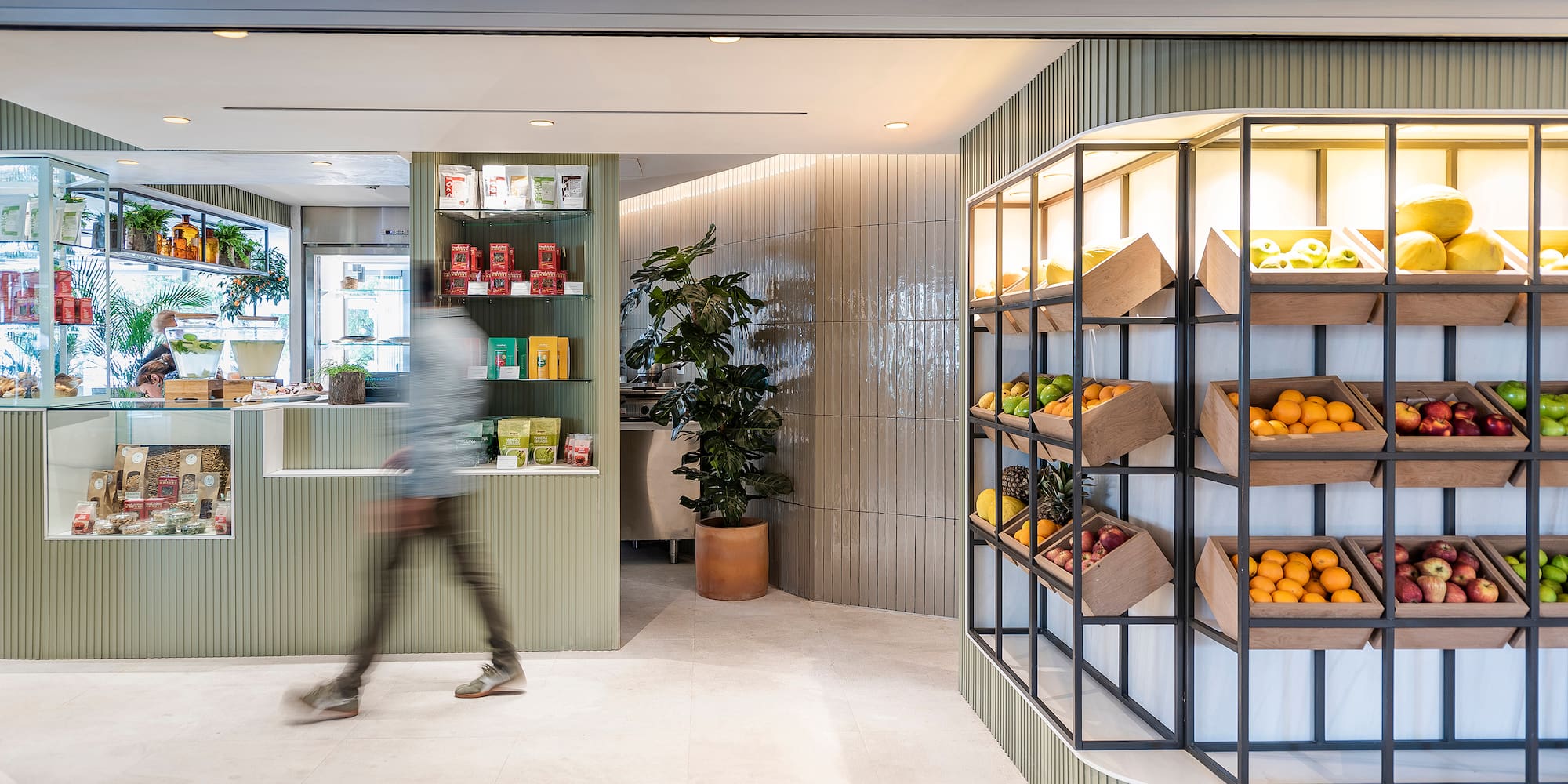 a person walking past a display of fruit