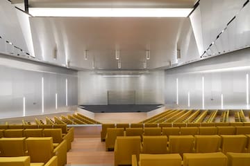 a large auditorium with yellow seats