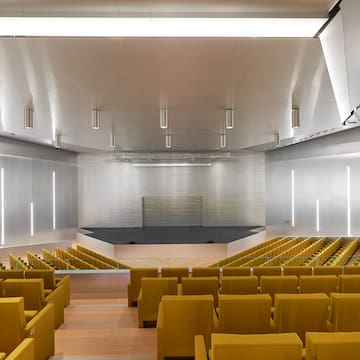 a large auditorium with yellow seats