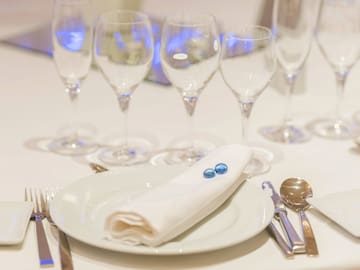 a table with glasses and a plate with a napkin on it