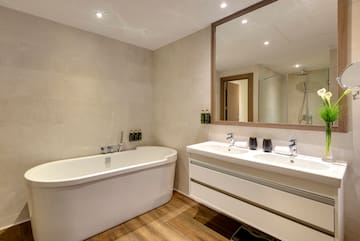 a bathroom with a tub and sink