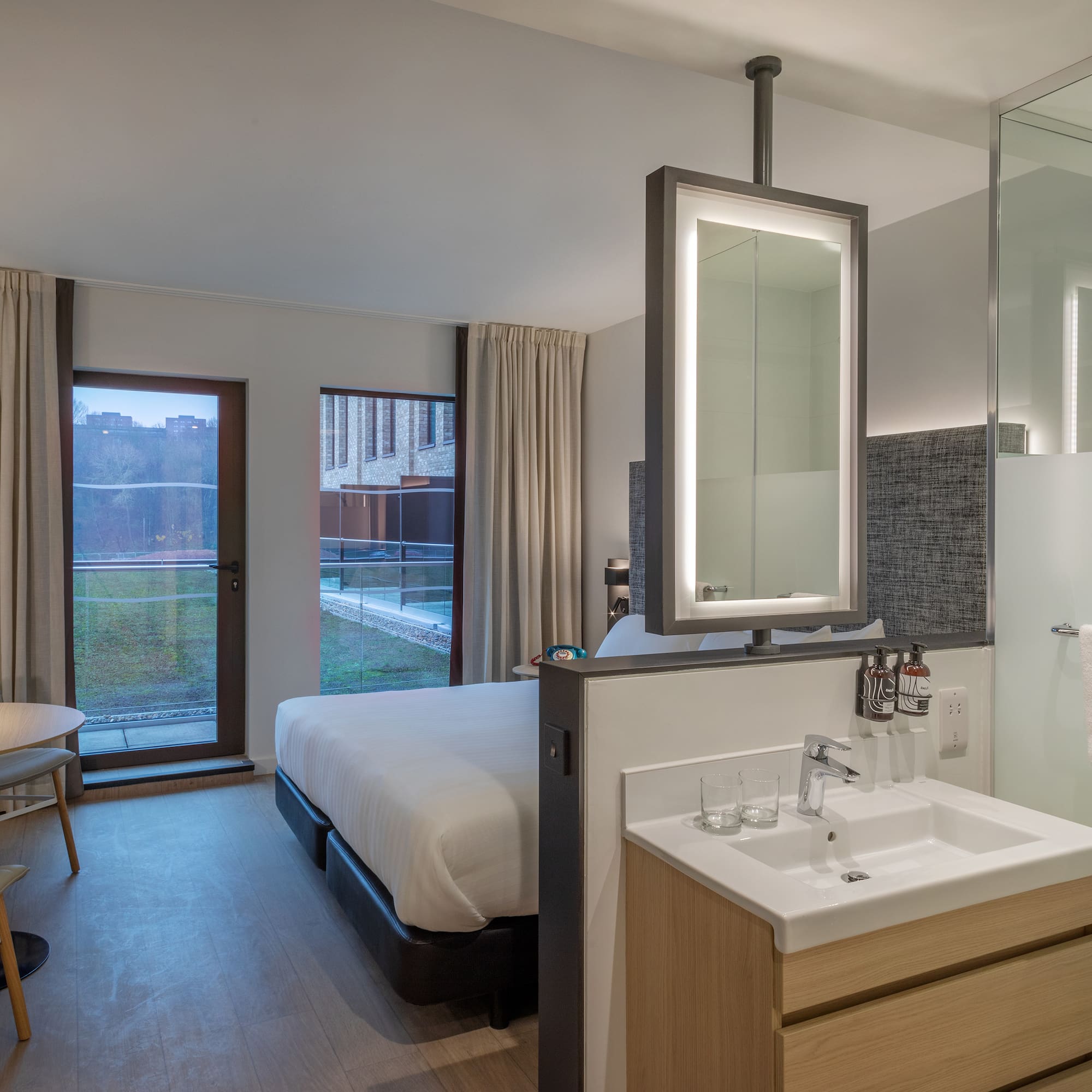 a bathroom with a bed and sink