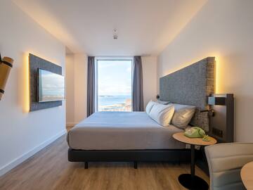 a room with a large bed and a large window
