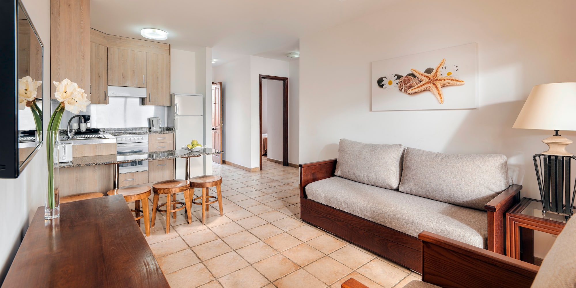 a living room with a couch and kitchen