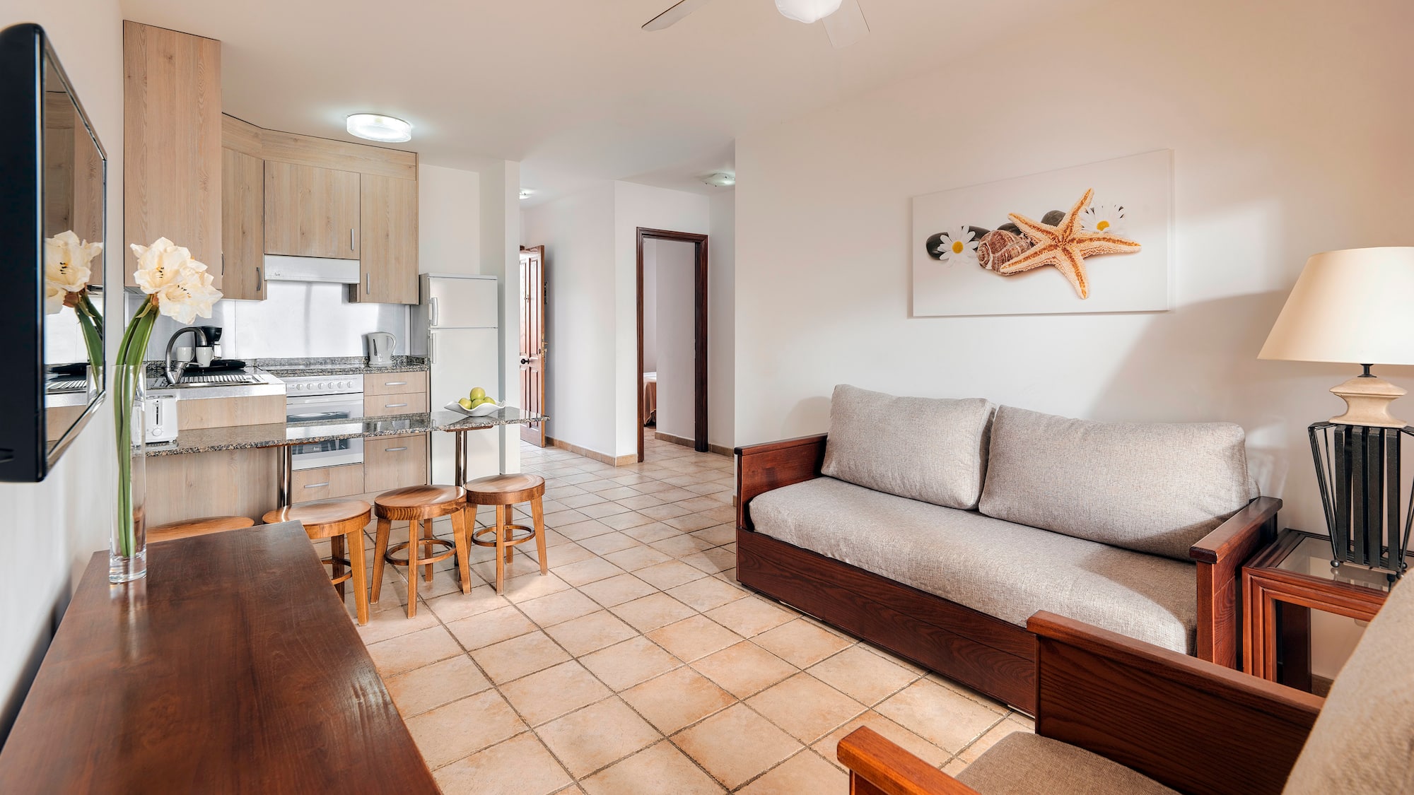 a living room with a couch and kitchen