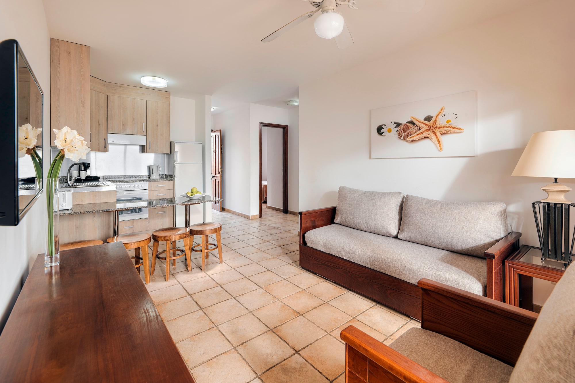 a living room with a couch and kitchen