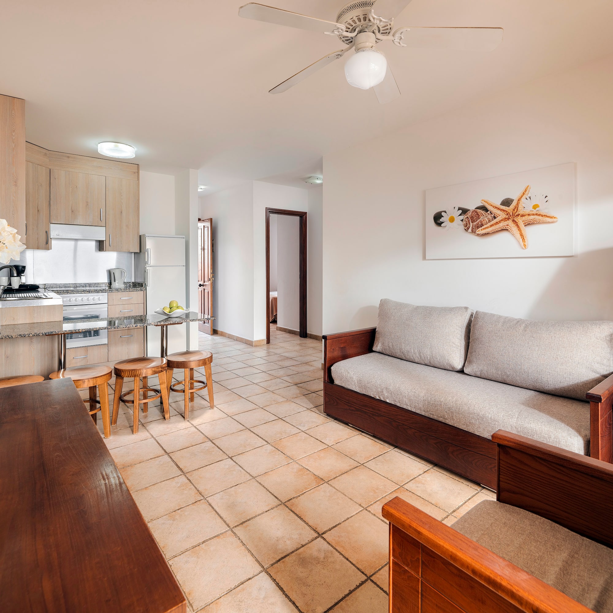 a living room with a couch and kitchen