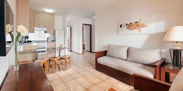 a living room with a couch and kitchen