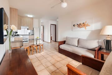 a living room with a couch and kitchen