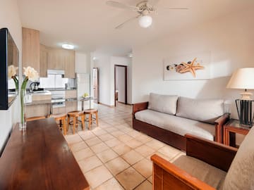 a living room with a couch and kitchen