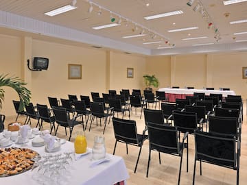 a room with a table set up for a conference