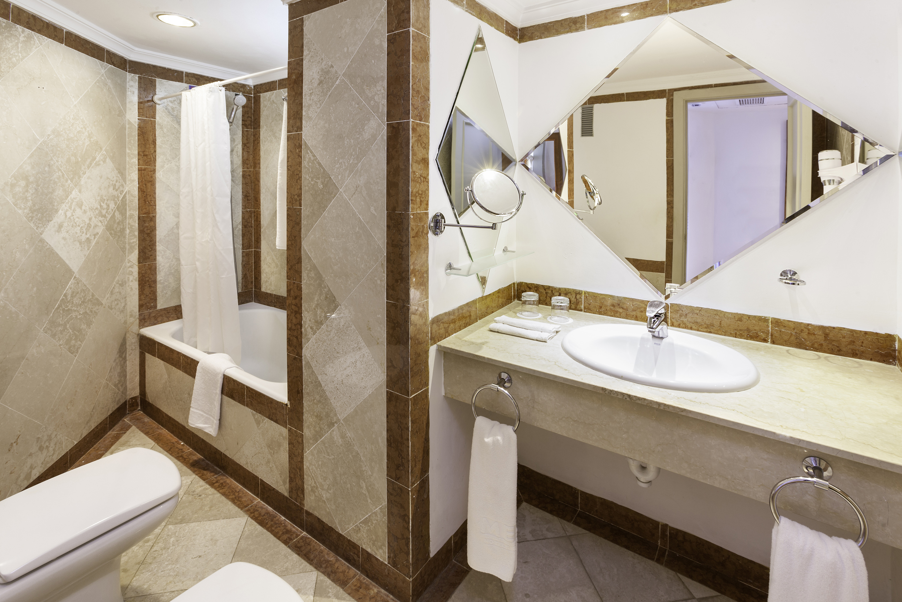 a bathroom with a mirror and sink