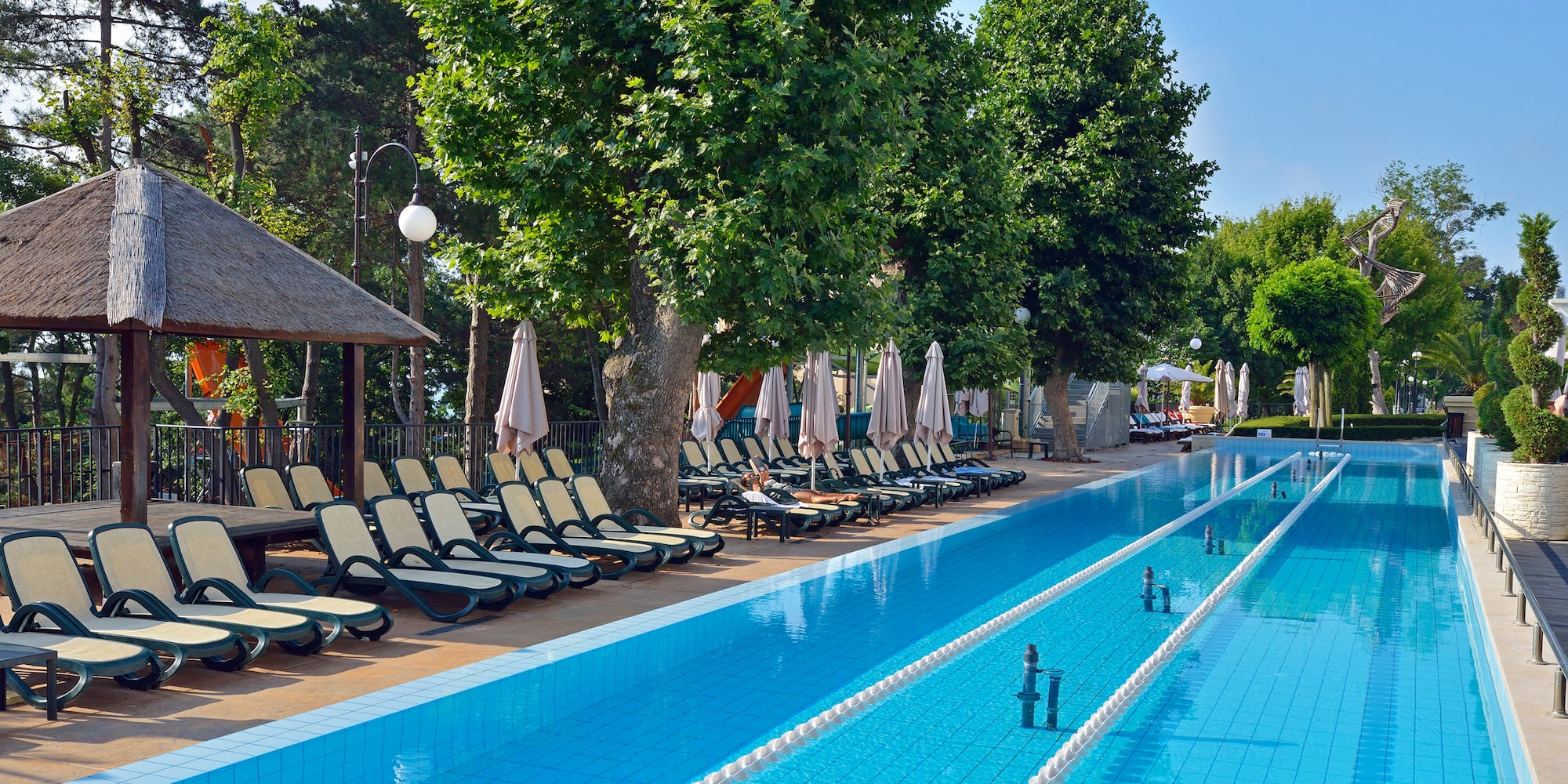 a pool with lounge chairs and umbrellas