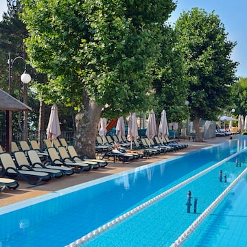 a pool with lounge chairs and umbrellas