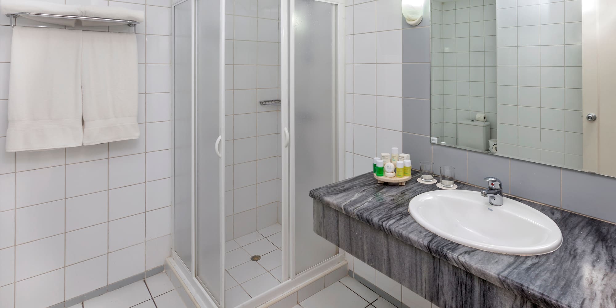 a bathroom with a shower and sink