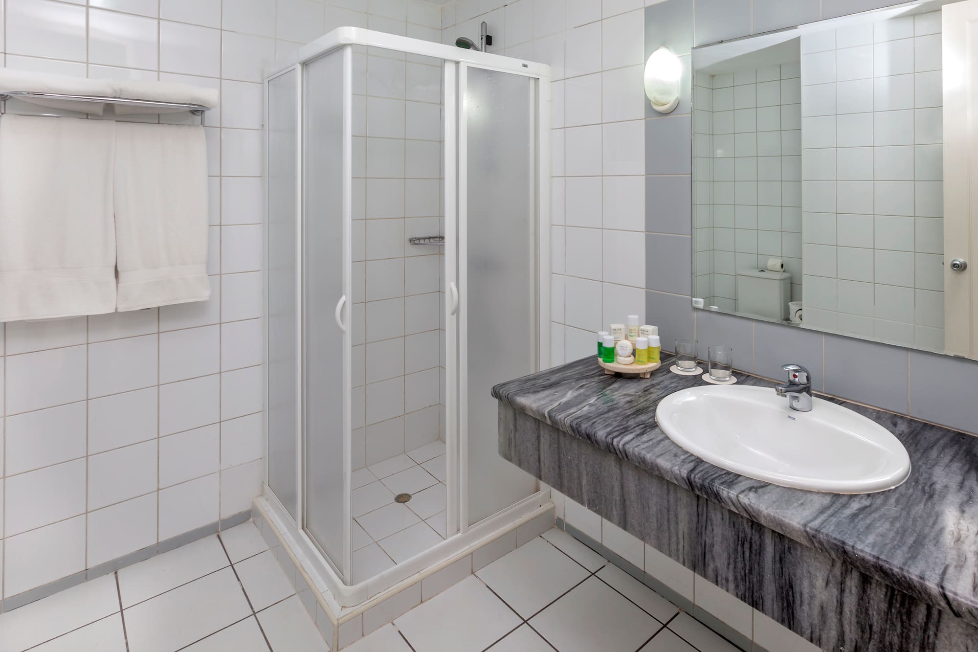 a bathroom with a shower and sink