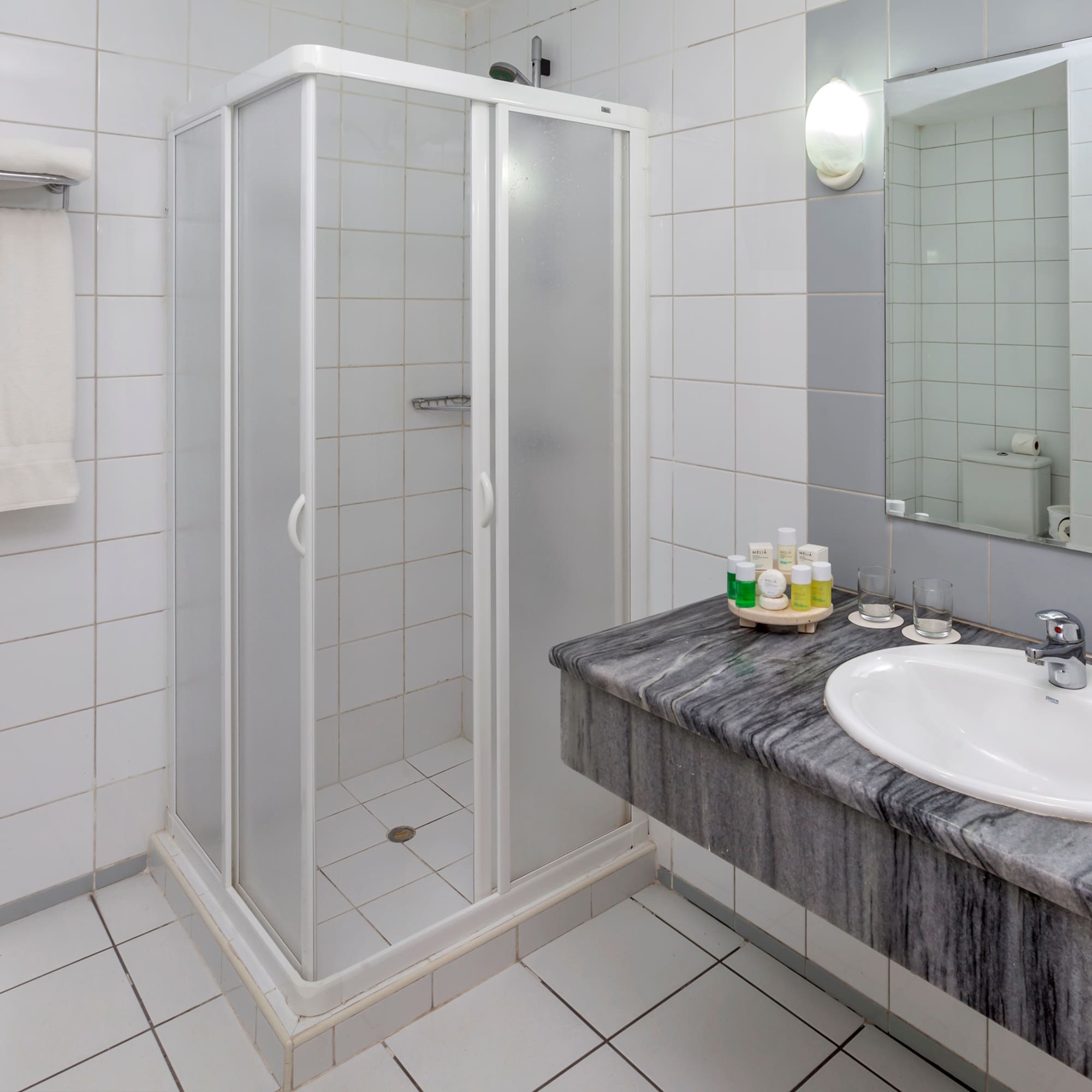 a bathroom with a shower and sink