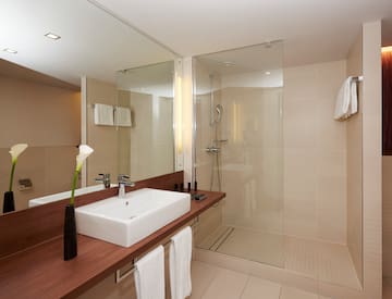 a bathroom with a glass shower and sink