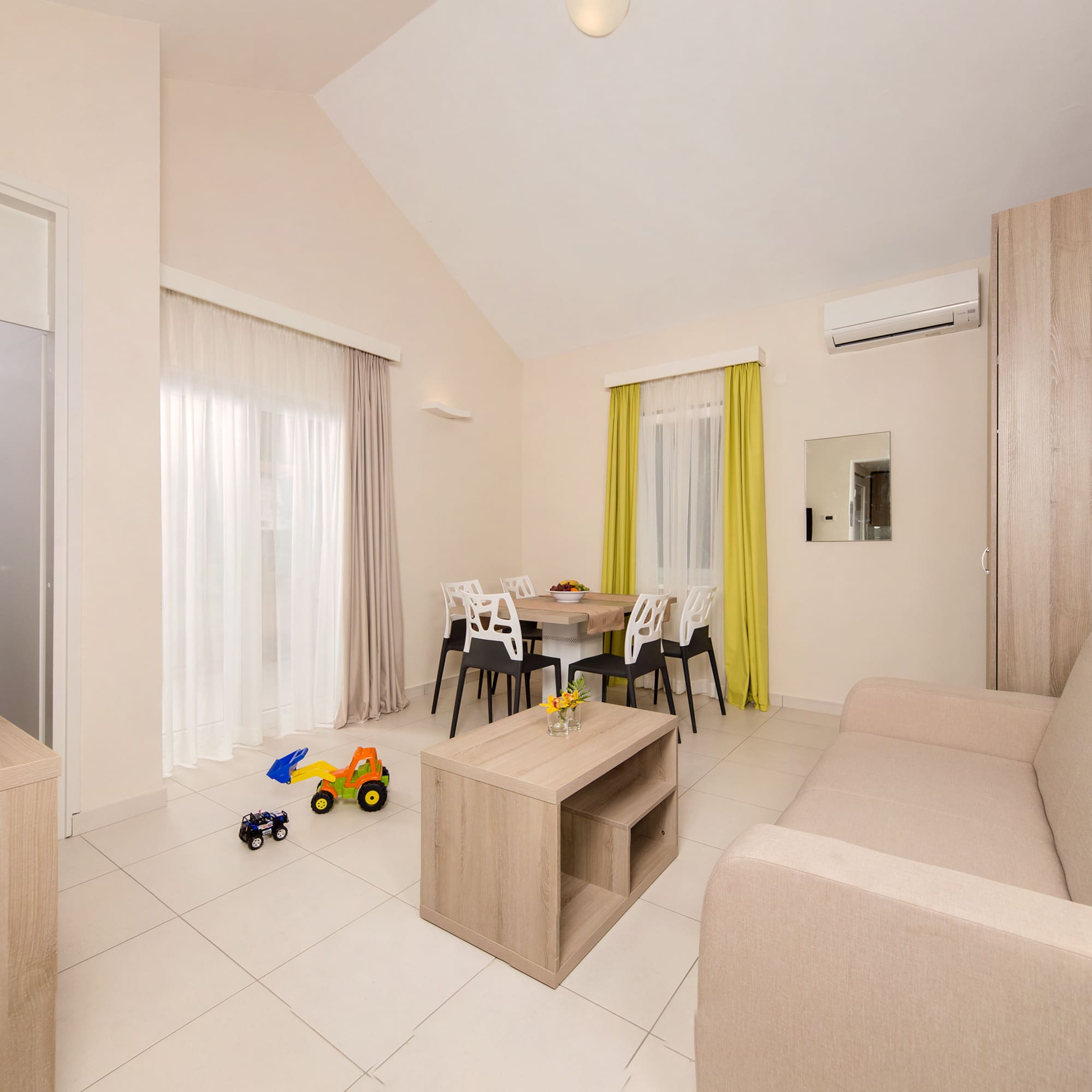 a living room with a table and chairs