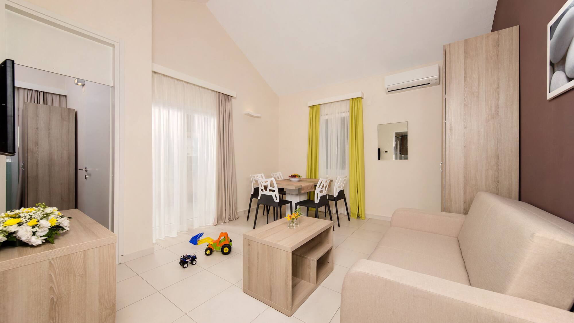 a living room with a table and chairs