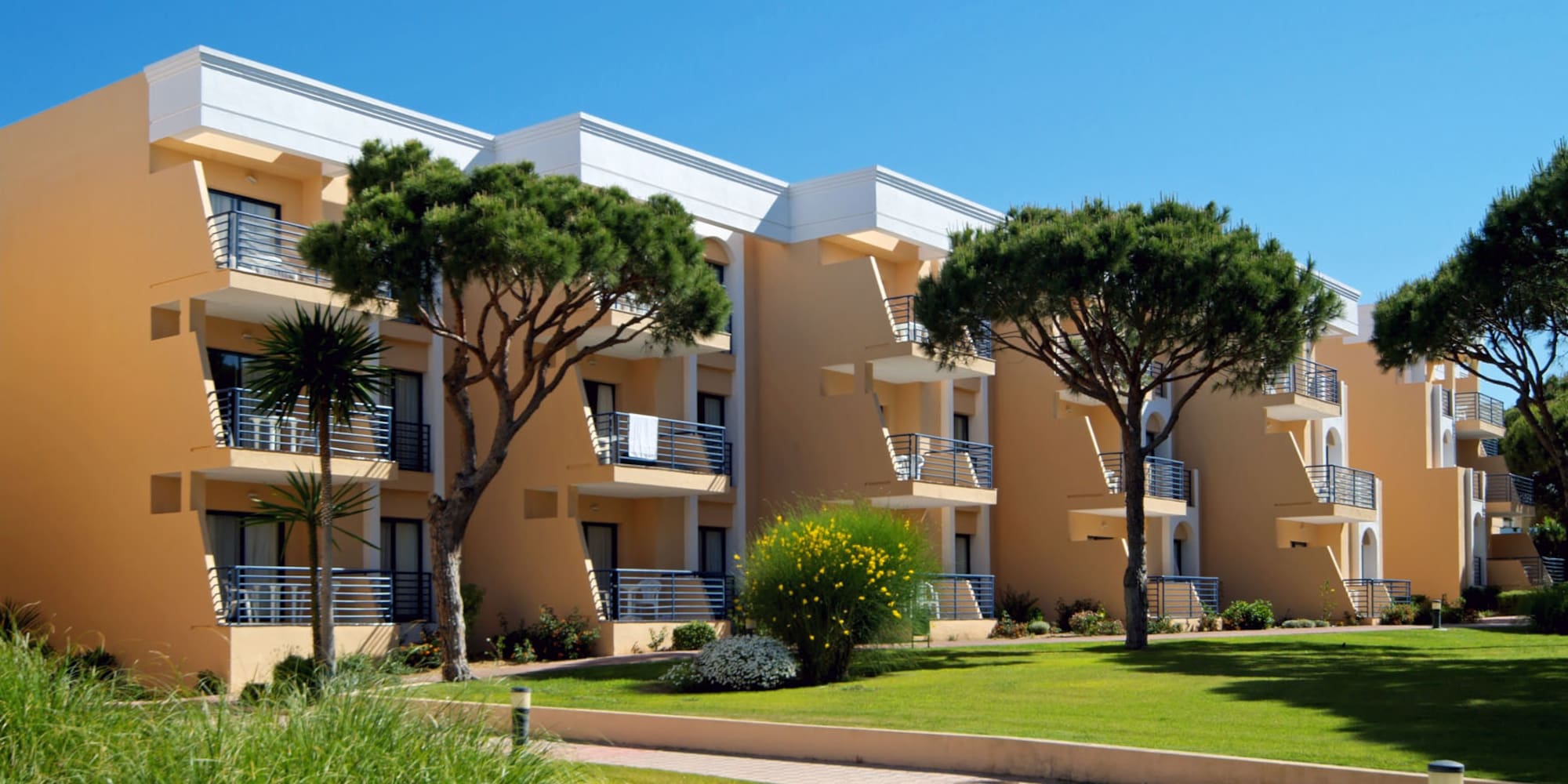 a building with trees and grass
