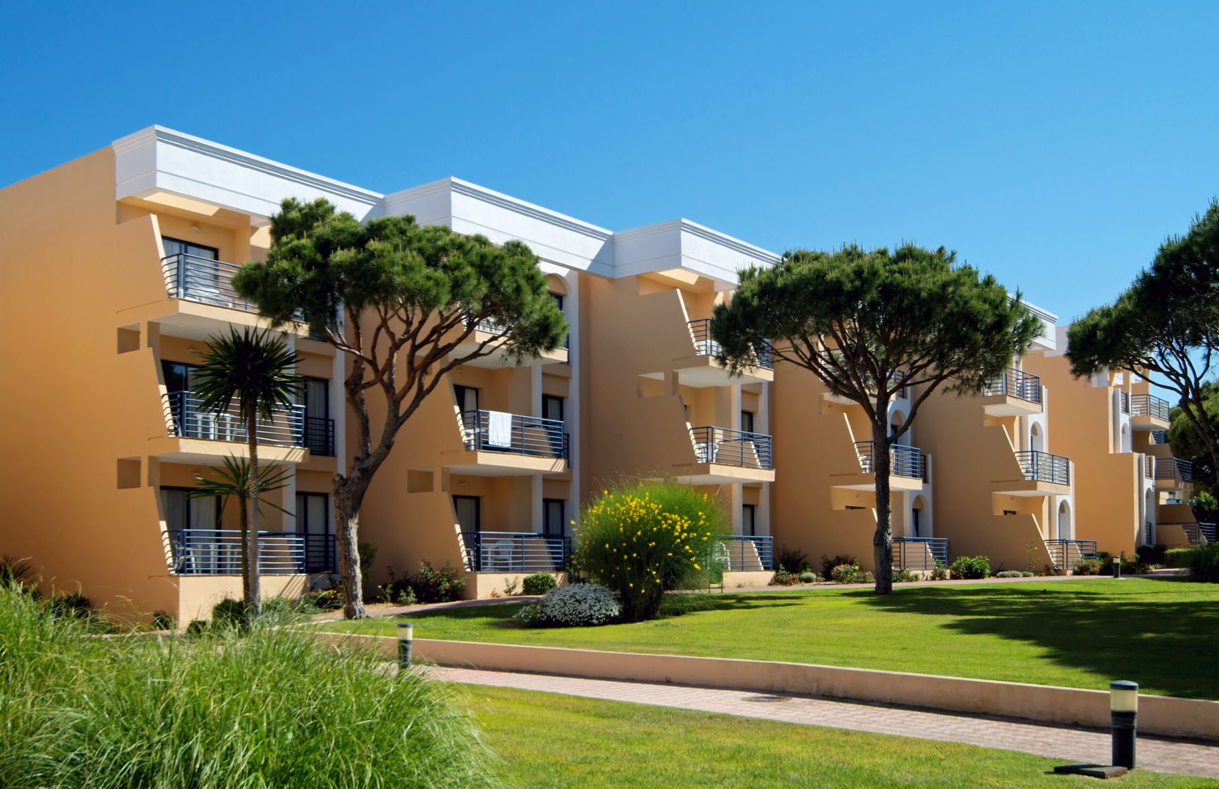 a building with trees and grass
