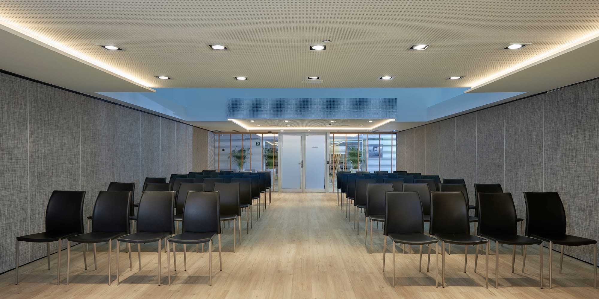 a room with chairs and a door