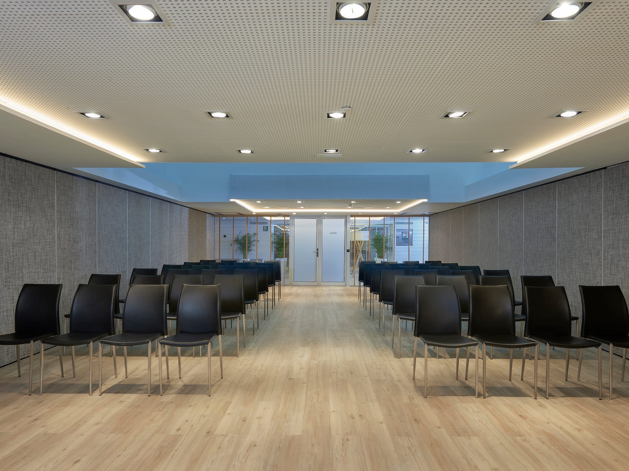 a room with chairs and a door