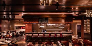 a bar with chairs and tables