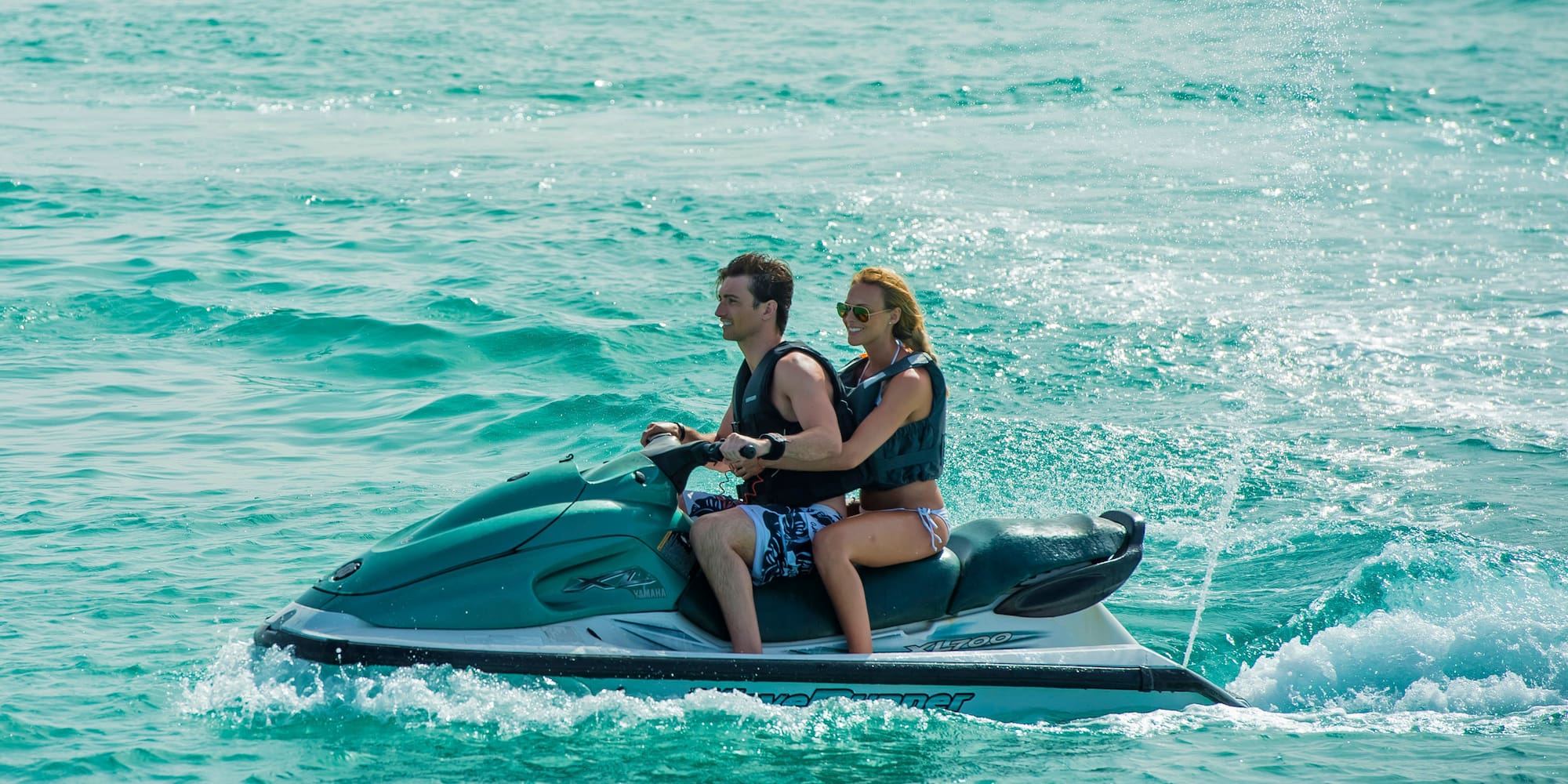a man and woman on a jet ski