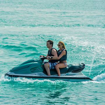 a man and woman on a jet ski