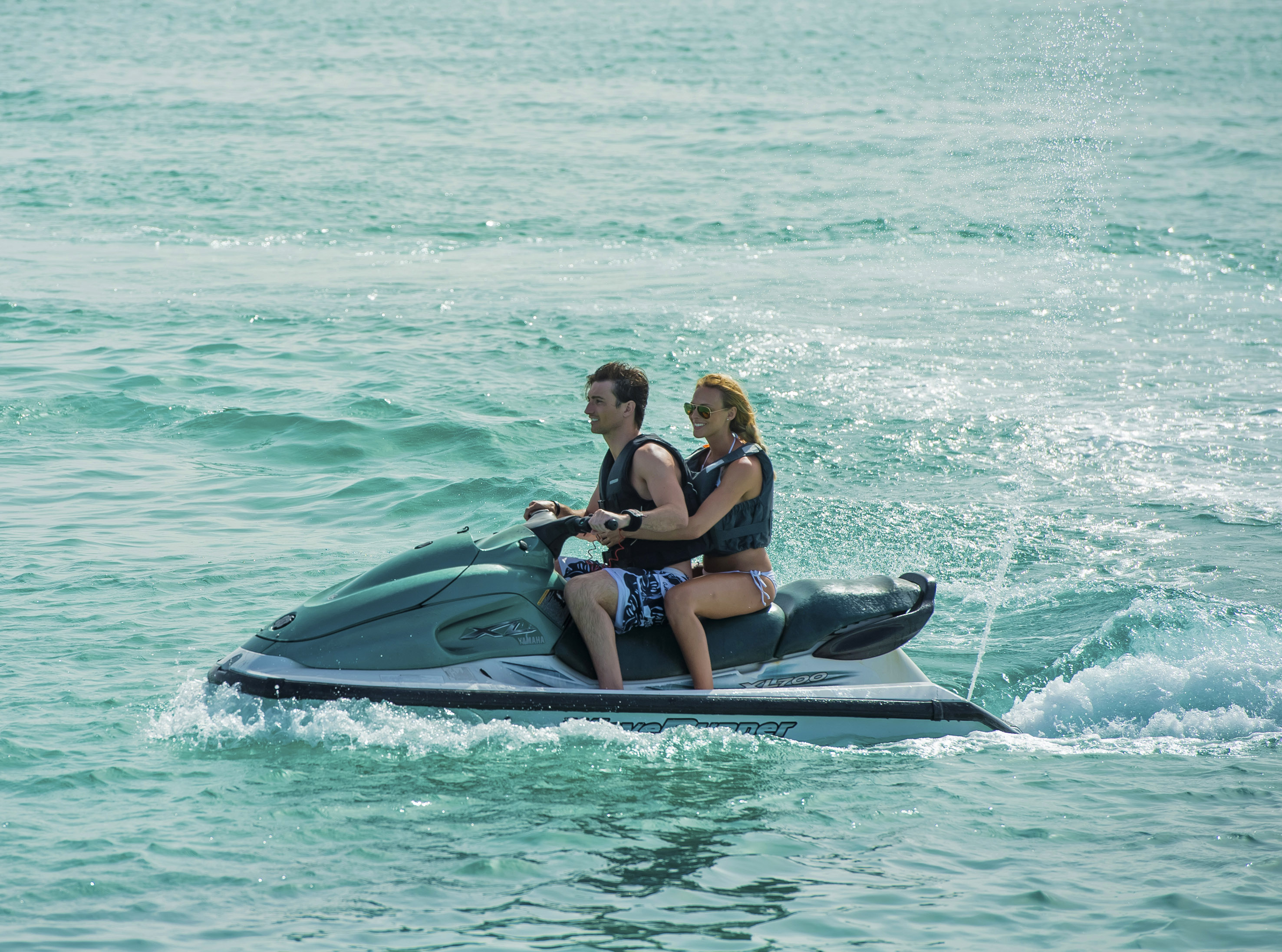 a man and woman on a jet ski