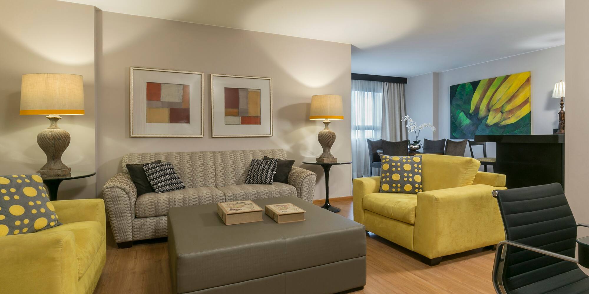 a living room with yellow and grey furniture