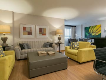 a living room with yellow and grey furniture