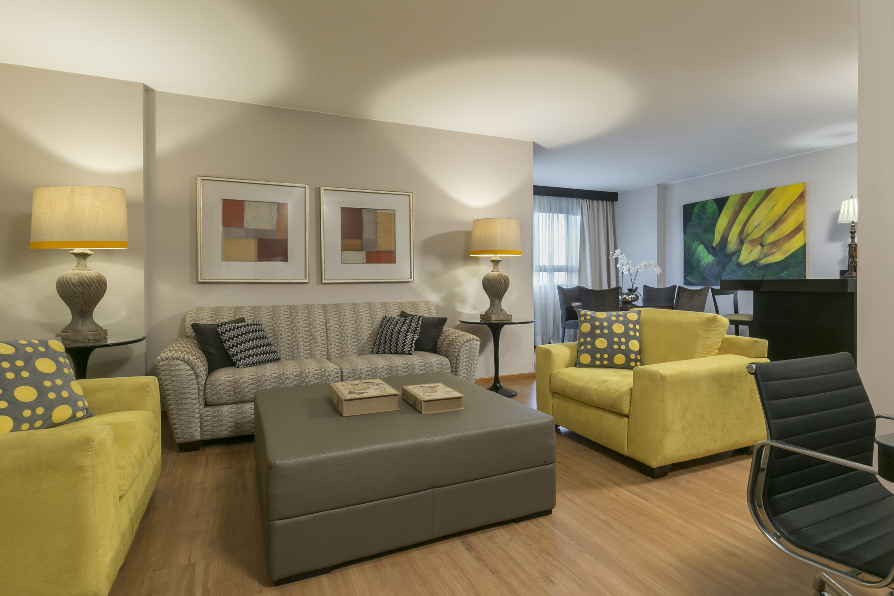 a living room with yellow and grey furniture