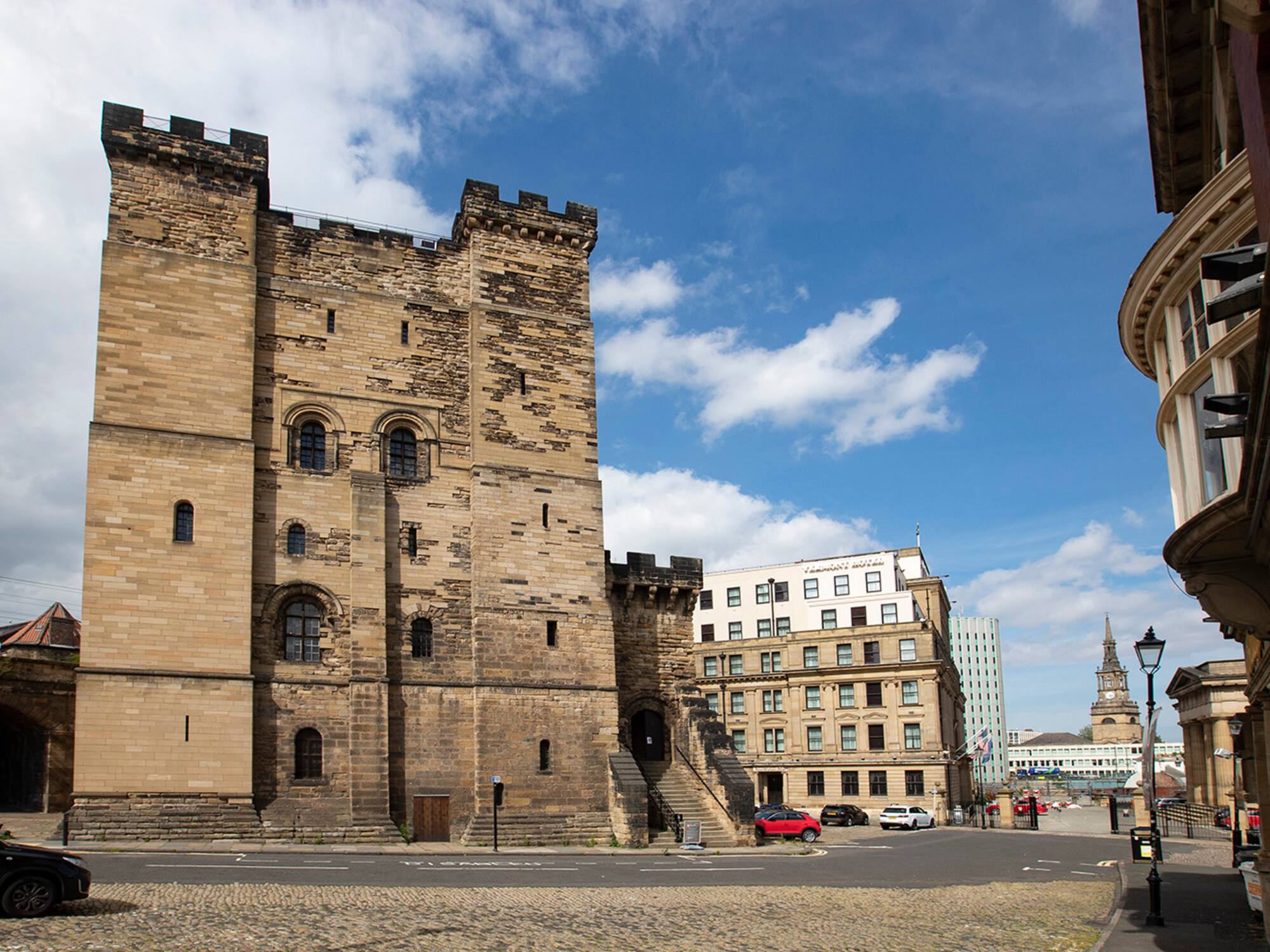 a stone building with a stone wall and a stone road