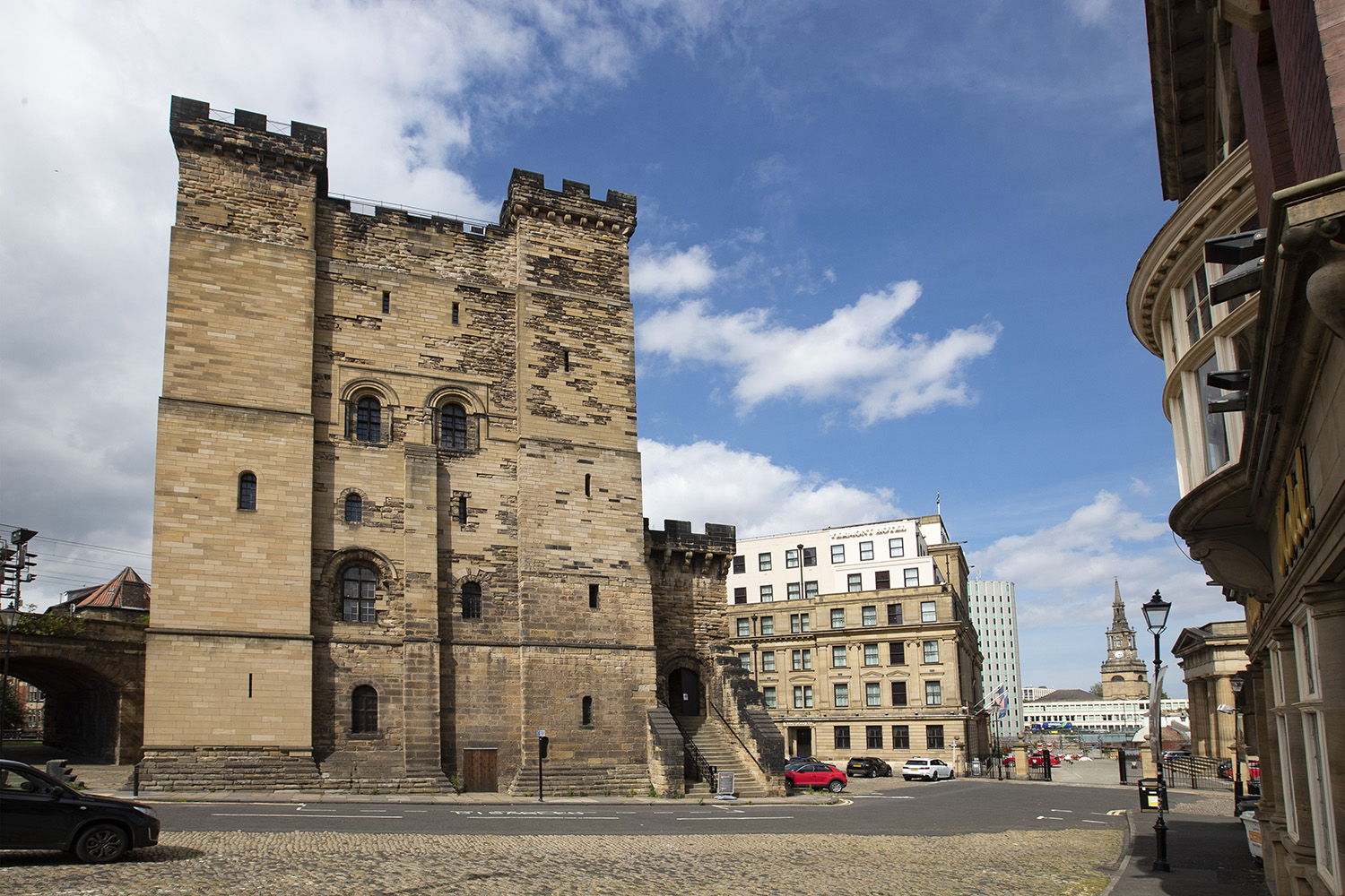 a stone building with a stone wall and a stone road